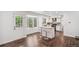 Bright kitchen features white cabinets, stainless appliances, and a center island with seating at 13701 Yank Way, Arvada, CO 80004