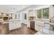 Bright kitchen with white cabinets, stainless appliances, and an open layout at 13701 Yank Way, Arvada, CO 80004