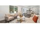 Comfortable living room with stylish furniture, hardwood floors, and ample natural light at 13701 Yank Way, Arvada, CO 80004