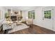 Bright living room featuring a brick fireplace, hardwood floors, and cozy seating at 13701 Yank Way, Arvada, CO 80004