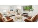 Bright living room featuring large windows, modern furniture, and elegant decor at 13701 Yank Way, Arvada, CO 80004