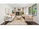 Cozy living room featuring a brick fireplace, hardwood floors, and comfortable seating at 13701 Yank Way, Arvada, CO 80004
