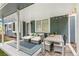 Covered patio features comfortable seating, a dining area, and string lights at 13701 Yank Way, Arvada, CO 80004