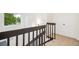 Bright stairway with dark wood railing leads to the upper level near a window with a view of nature at 13701 Yank Way, Arvada, CO 80004