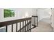 Bright stairway with dark wood railing leads to the upper level near a window with a view of nature at 13701 Yank Way, Arvada, CO 80004