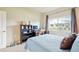 This bedroom is complete with built-in shelving, a large window and neutral walls at 3595 E 124Th Pl, Thornton, CO 80241