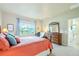 This bedroom features a large window with plenty of natural light and wood furnishings at 3595 E 124Th Pl, Thornton, CO 80241