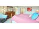 This bedroom features an ensuite bathroom, wood furnishings, and colorful floral decor at 3595 E 124Th Pl, Thornton, CO 80241