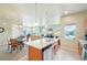 Open kitchen layout with an island, stainless steel appliances, and access to the dining and living areas at 3595 E 124Th Pl, Thornton, CO 80241