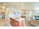 Open floor plan with a kitchen island, dining area, and comfortable living space at 3595 E 124Th Pl, Thornton, CO 80241