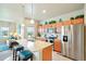 Bright kitchen featuring an island, stainless steel appliances, and ample cabinet space at 3595 E 124Th Pl, Thornton, CO 80241
