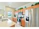 Well-lit kitchen with stainless steel appliances, an island, and plenty of cabinet space at 3595 E 124Th Pl, Thornton, CO 80241