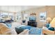 Living room featuring comfortable seating, a TV, and a bright home office space at 3595 E 124Th Pl, Thornton, CO 80241