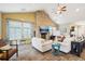 Bright living room boasts a stone fireplace, vaulted ceiling, and abundant natural light at 3595 E 124Th Pl, Thornton, CO 80241