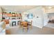 Open concept living area featuring a kitchen island, dining space and a cozy living area at 3595 E 124Th Pl, Thornton, CO 80241