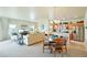 Inviting living area featuring an open floor plan connecting the kitchen, dining, and living spaces at 3595 E 124Th Pl, Thornton, CO 80241