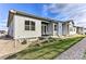 Inviting outdoor patio with seating and a well-maintained lawn create a perfect relaxation spot at 6770 Zebra Grass Ln, Parker, CO 80138