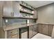 Modern bar with a wine fridge, open shelving, and stylish countertops at 6770 Zebra Grass Ln, Parker, CO 80138