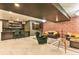Finished basement area with a stylish bar, exposed brick wall, and comfortable seating at 6770 Zebra Grass Ln, Parker, CO 80138