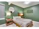 Cozy bedroom with green walls, modern lamps, and comfortable bedding at 6770 Zebra Grass Ln, Parker, CO 80138