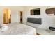 Modern bedroom featuring a floating dresser, large TV, and a view to the ensuite at 6770 Zebra Grass Ln, Parker, CO 80138