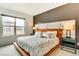 Cozy bedroom with a large window, a padded headboard, and stylish nightstands at 6770 Zebra Grass Ln, Parker, CO 80138