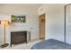 Simple bedroom with a dresser, a large piece of artwork, and a cozy bed at 6770 Zebra Grass Ln, Parker, CO 80138
