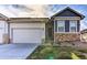 Charming home showcases a two-car garage, stone accents, and well-maintained landscaping at 6770 Zebra Grass Ln, Parker, CO 80138