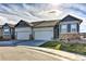 Charming home with a two-car garage, stone accents, and well-maintained landscaping at 6770 Zebra Grass Ln, Parker, CO 80138