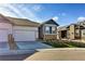 Charming home with a two-car garage, stone accents, and a well-manicured lawn offers curb appeal at 6770 Zebra Grass Ln, Parker, CO 80138