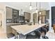 Modern kitchen featuring a large island with seating, sleek countertops, and stainless steel appliances at 6770 Zebra Grass Ln, Parker, CO 80138