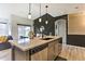 Modern kitchen island with stainless steel appliances and pendant lighting above the countertops at 6770 Zebra Grass Ln, Parker, CO 80138