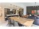 Open-concept living space features dining area and a modern kitchen with a breakfast bar at 6770 Zebra Grass Ln, Parker, CO 80138