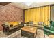 Stylish basement living area with exposed brick, plush seating, and elegant accents, perfect for relaxation and entertainment at 6770 Zebra Grass Ln, Parker, CO 80138