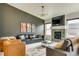 Comfortable living room with a fireplace, large windows and stylish decor at 6770 Zebra Grass Ln, Parker, CO 80138