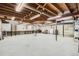 Spacious unfinished basement with exposed beams, concrete floors, and ample room for storage or customization at 2648 S Wadsworth Way, Lakewood, CO 80227