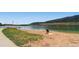 Scenic lakeside beach view with calm waters, sandy shore, and distant hills perfect for outdoor recreation at 2648 S Wadsworth Way, Lakewood, CO 80227