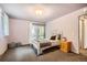 Inviting bedroom with natural light, simple decor, and view to the patio area at 2648 S Wadsworth Way, Lakewood, CO 80227