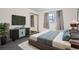 Comfortable bedroom with a modern bed, dresser, and ample closet space at 2648 S Wadsworth Way, Lakewood, CO 80227