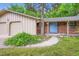 Charming home featuring a brick facade, a manicured lawn, a blue front door, and an attached two car garage at 2648 S Wadsworth Way, Lakewood, CO 80227