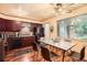 Eat-in kitchen featuring dark cabinets, dining table set with seating, and large windows for a naturally lit space at 2648 S Wadsworth Way, Lakewood, CO 80227