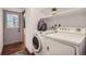 Laundry room with stacked washer and dryer, overhead shelving, and easy access to the side exterior door at 2648 S Wadsworth Way, Lakewood, CO 80227