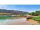Picturesque waterfront scene with paddle boats, lush vegetation, and scenic mountain backdrop at 2648 S Wadsworth Way, Lakewood, CO 80227