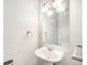 Clean half bathroom featuring a pedestal sink, mirror, and modern lighting at 16835 E Harvard Pl, Aurora, CO 80013