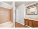 Bathroom featuring tub-shower combo and vanity with wood cabinets and plenty of counter space at 16835 E Harvard Pl, Aurora, CO 80013