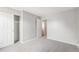 Neutral bedroom featuring plush carpeting, closet and access to the bathroom at 16835 E Harvard Pl, Aurora, CO 80013