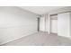 Neutral bedroom featuring gray carpet, a closet, and a light gray painted wall at 16835 E Harvard Pl, Aurora, CO 80013