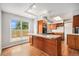 Spacious kitchen with wooden cabinets, stainless appliances, and hardwood floors at 16835 E Harvard Pl, Aurora, CO 80013