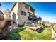 Home exterior featuring a deck with seating, a backyard, and landscaped surroundings at 4968 Montvale Dr, Highlands Ranch, CO 80130