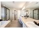Bright bathroom with dual sinks, a walk-in shower, and a separate soaking tub at 4968 Montvale Dr, Highlands Ranch, CO 80130